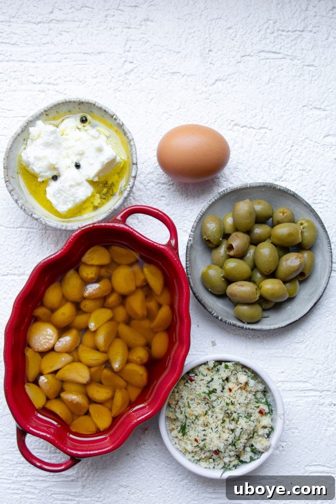 Close-up of golden-fried goats cheese stuffed olives on a plate