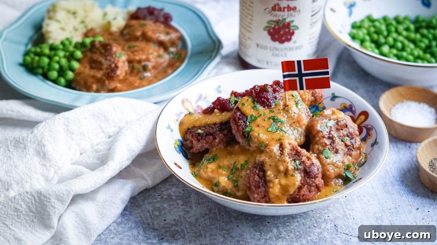Served Vegan Kjøttkaker with Lingonberry A plated dish of vegan Norwegian meatballs with gravy, mashed potatoes, and Lingonberry sauce, garnished with fresh parsley.