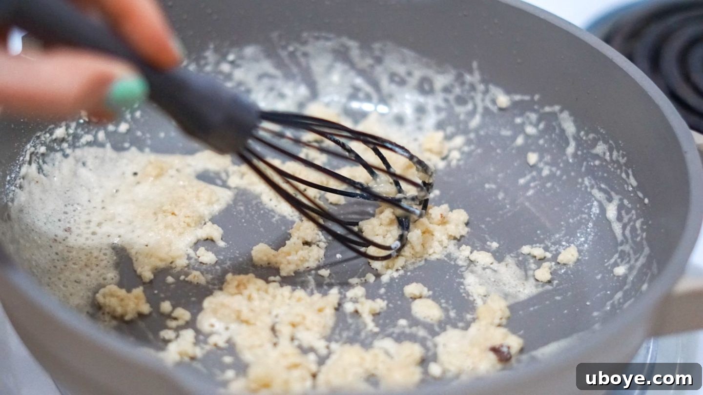 Making a Roux for Gravy Flour added to melted vegan butter in a pan, being whisked to create a roux.