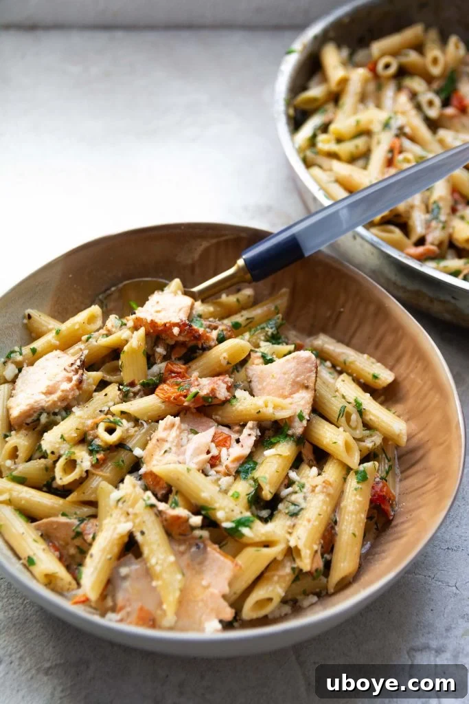 Tuscan Sunset Salmon Pasta 2 Delicious Creamy Salmon Tuscan Pasta dish, garnished with fresh herbs and Parmesan