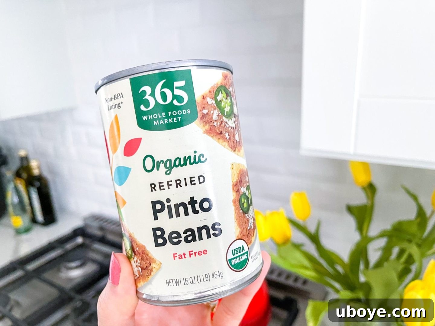 Epic Vegan 7 Layer Dip 15 A can of vegan-friendly refried pinto beans on a white kitchen counter, highlighting a convenient ingredient option.
