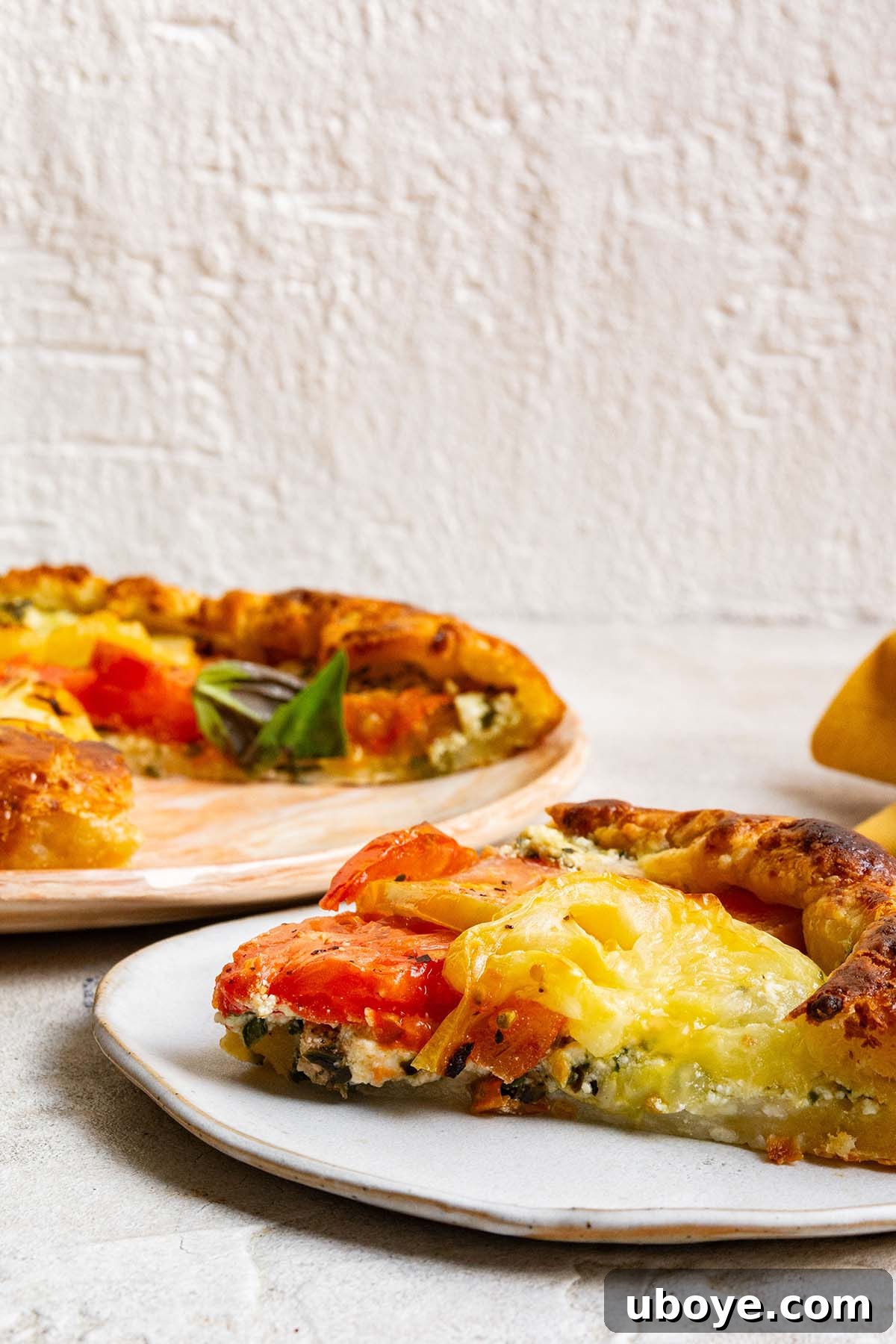 slice of summer tomato tart on a plate.