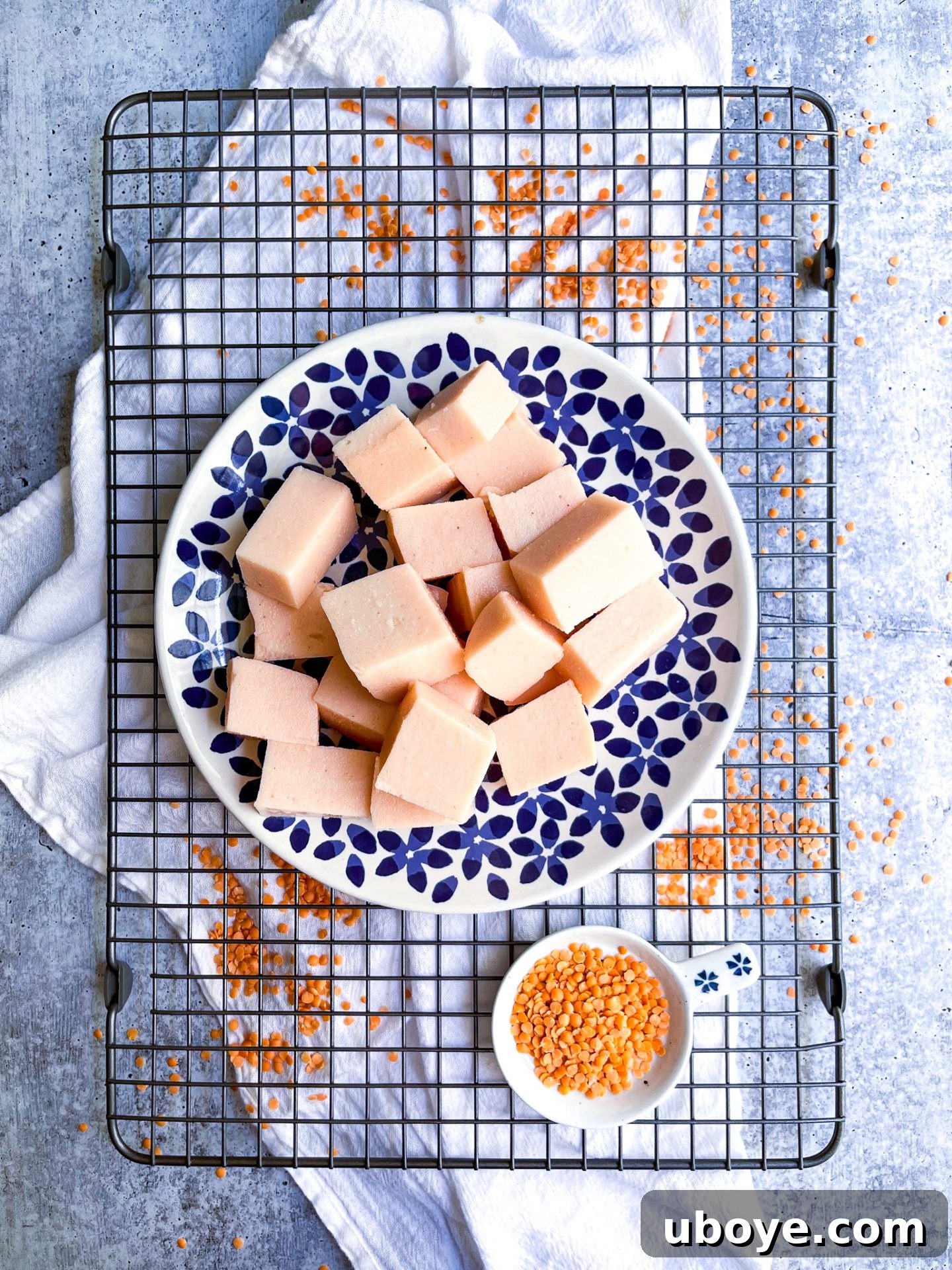 Crimson Lentil Blocks 7 Perfectly sliced pieces of homemade red lentil tofu arranged on a cutting board, ready for culinary use.