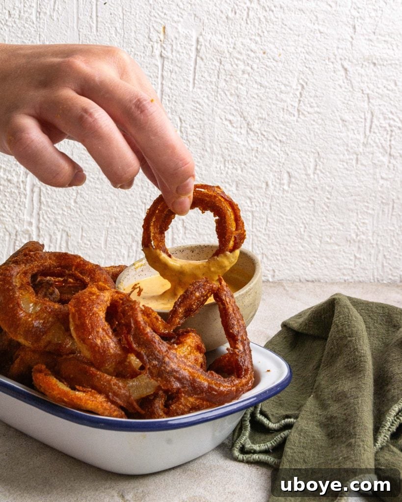 Crispy Onion Ring Burger 7 A plate with a burger and a side of beer-battered onion rings.