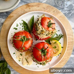 Pesto-Packed Tomato Delights 9 Roasted tomatoes on a white plate, ready to be served.