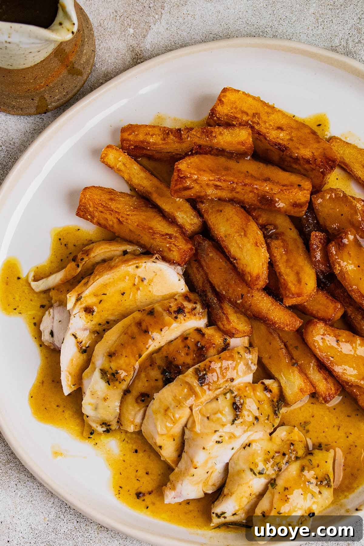 Sliced roasted chicken served with golden fried chips and a generous amount of rich gravy drizzled over. A true comfort food classic.
