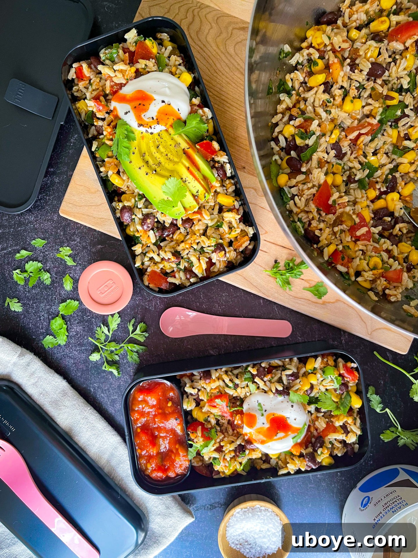 Fresh & Simple Summer Meal Prep 4 A black bento box filled with black bean, corn, and salsa rice salad, showcasing its vibrant ingredients, ready for a healthy meal prep lunch.