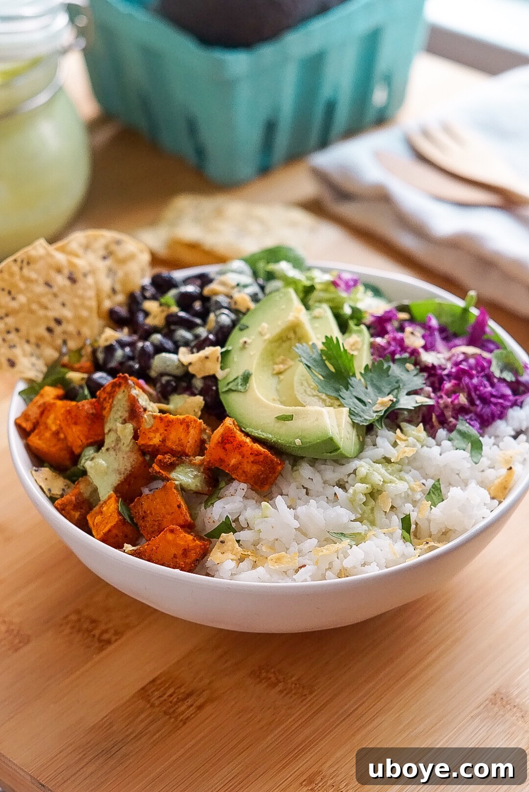 Fresh & Simple Summer Meal Prep 6 A vibrant sweet potato and black bean nourish bowl with a creamy cilantro lime sauce, showcasing a healthy, plant-based meal prep option.