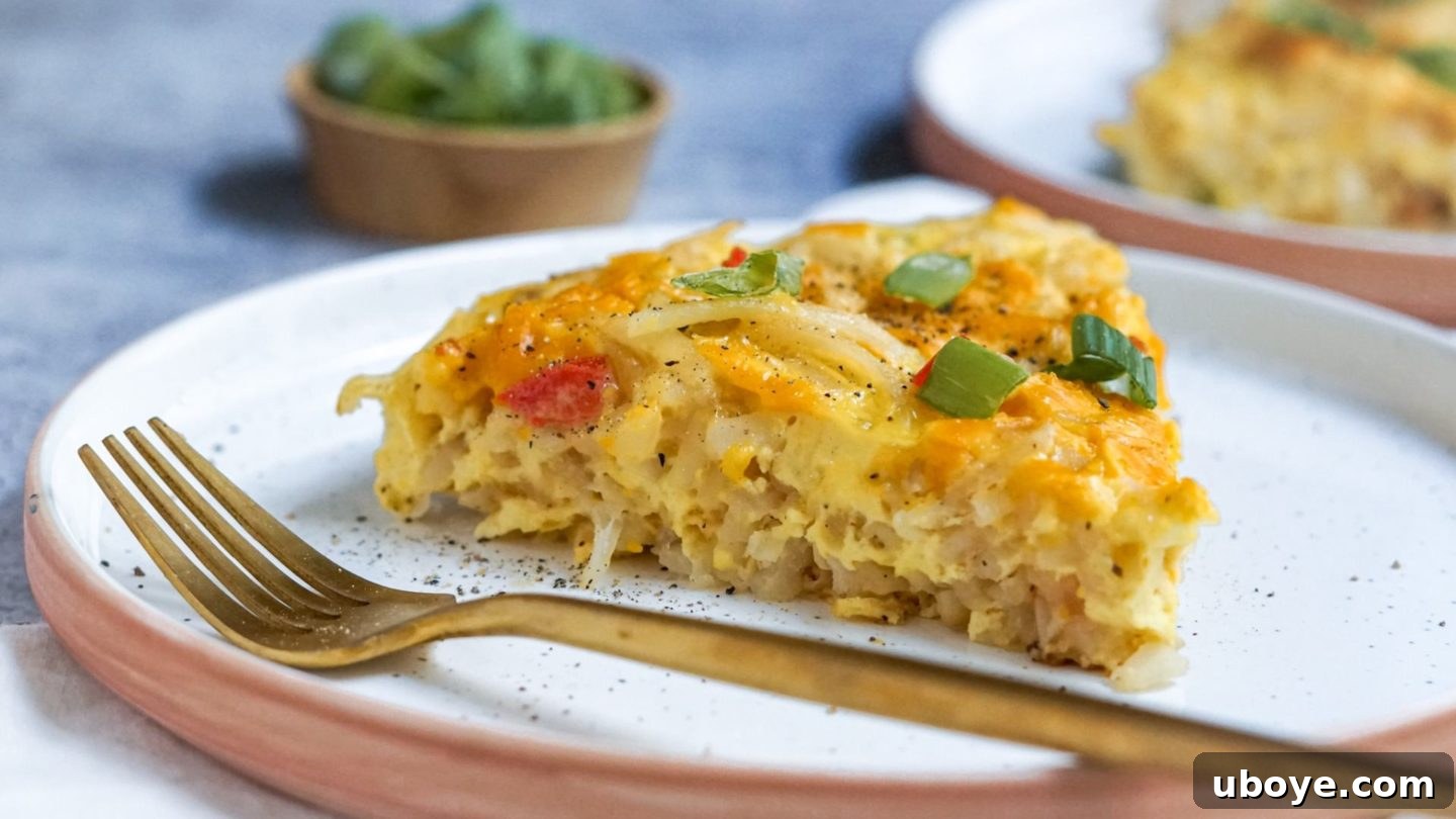 Fresh & Simple Summer Meal Prep 7 A slice of vegan egg and cheese hash brown casserole on a plate, showing its crispy top and creamy filling, ideal for breakfast or dinner meal prep.