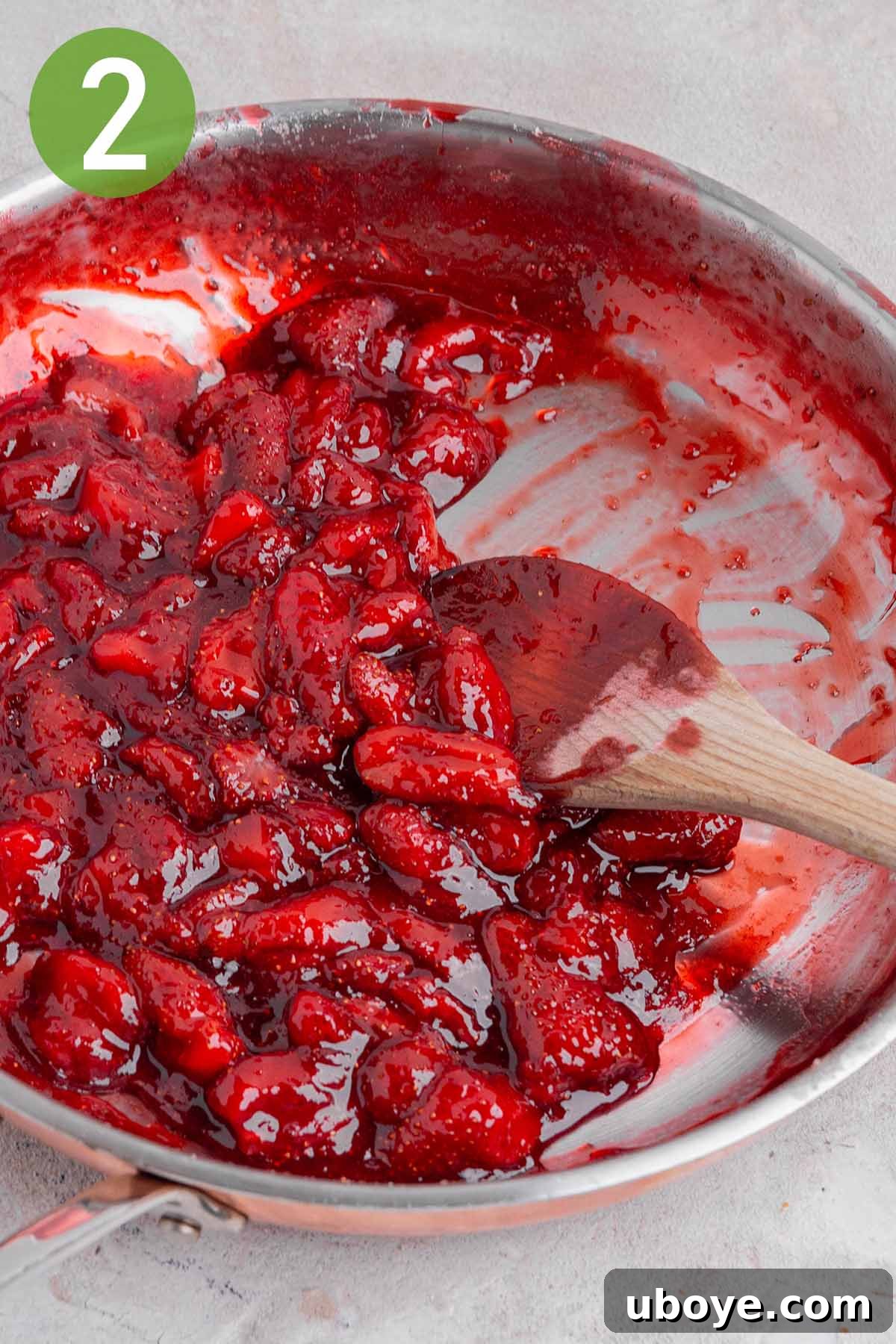 Strawberry Cream Dream Cake 4 Cooked strawberry jam simmering in a skillet, thickened to a perfect consistency.