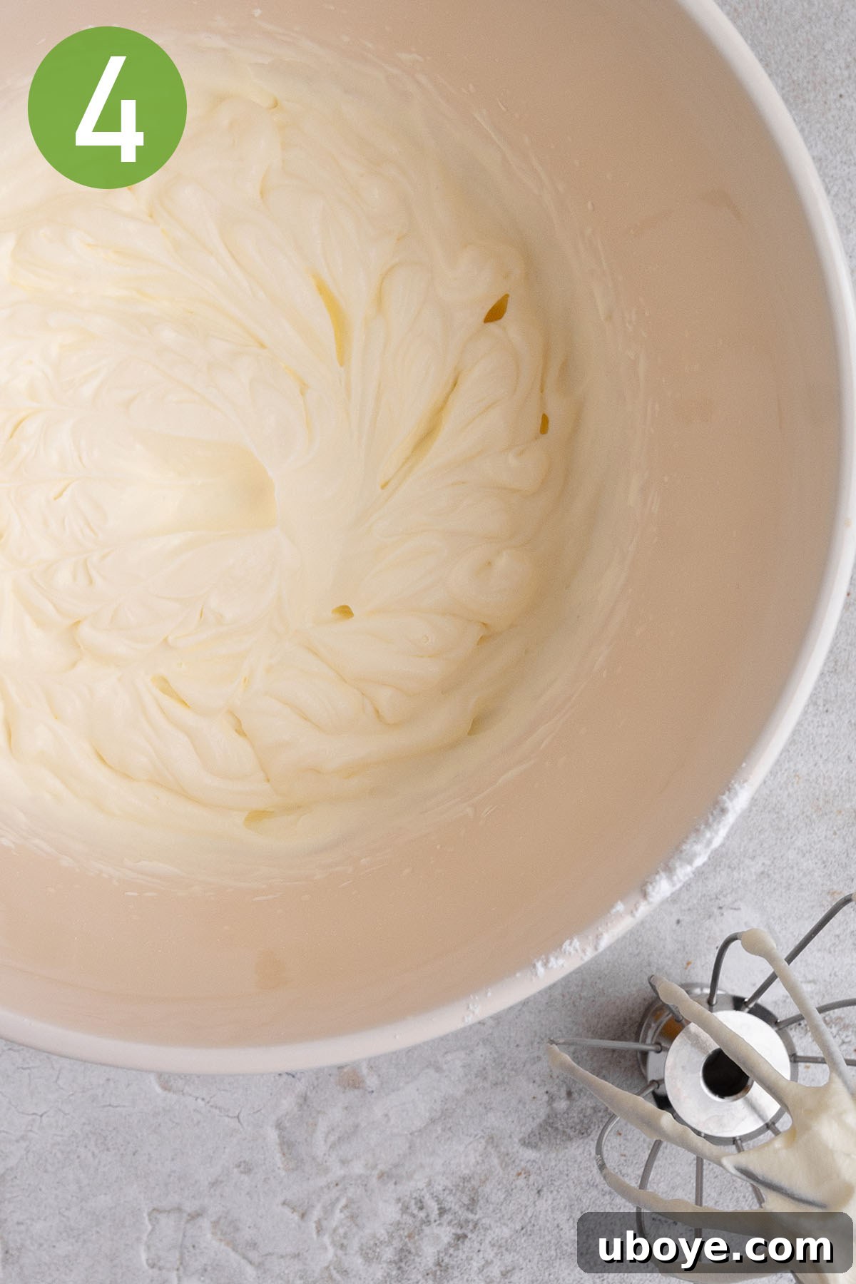 Strawberry Cream Dream Cake 6 Heavy whipping cream being whipped to stiff peaks in a large mixing bowl.