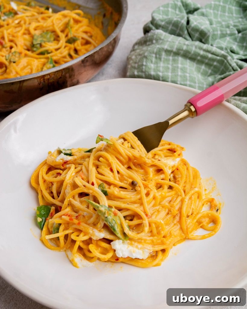 Roasted tomato and goats cheese pasta on a fork