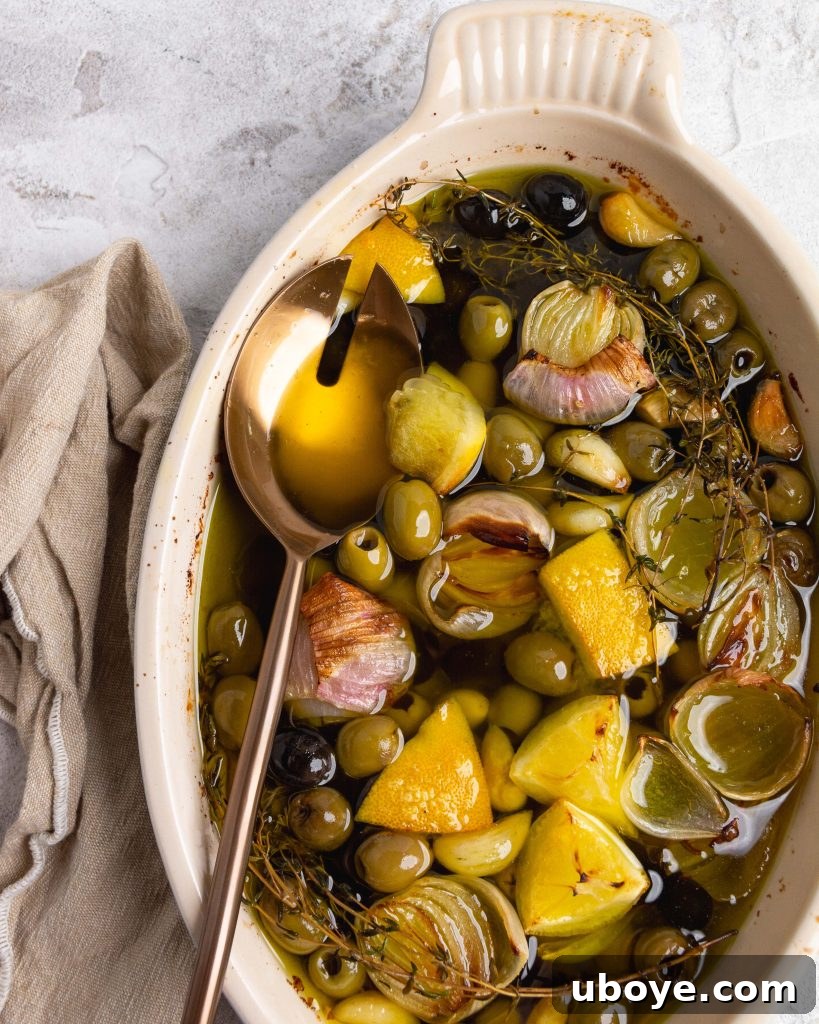 Oven-Roasted Olive Confit 4 A dish of baked olive confit with fresh herbs, ready for serving