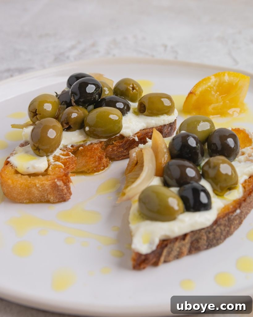 Oven-Roasted Olive Confit 8 A beautifully plated serving of baked olive confit with fresh thyme