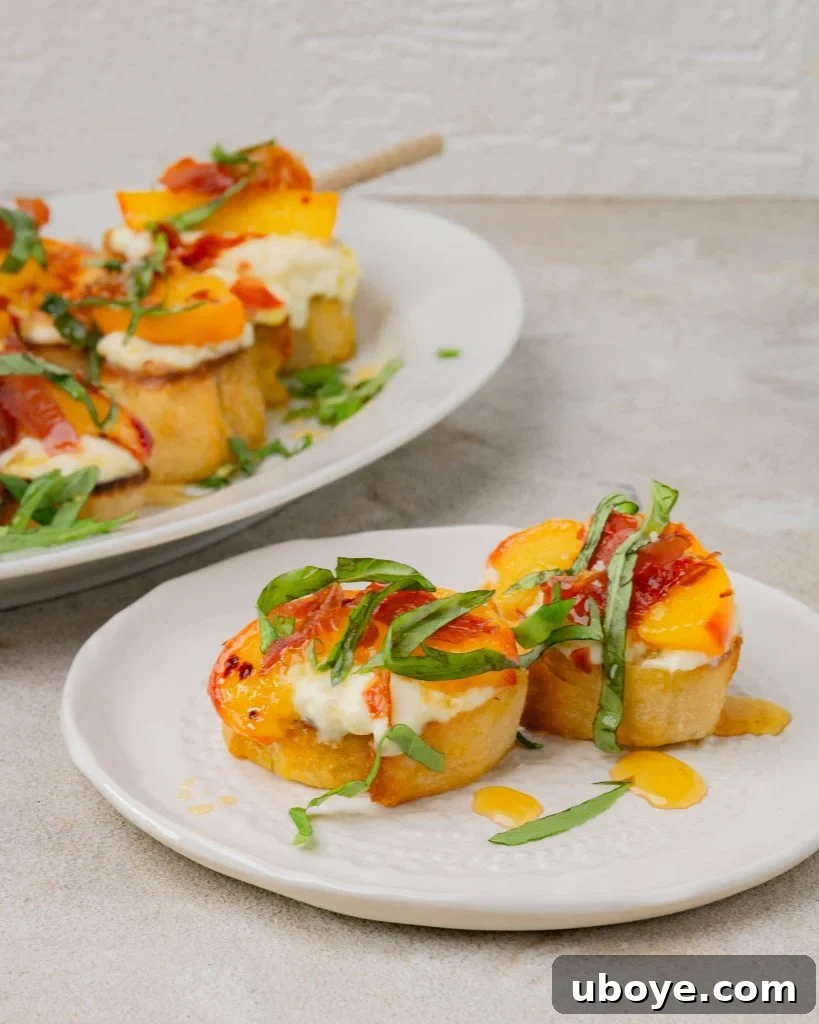 Assembled peach and prosciutto crostini with fresh basil garnish