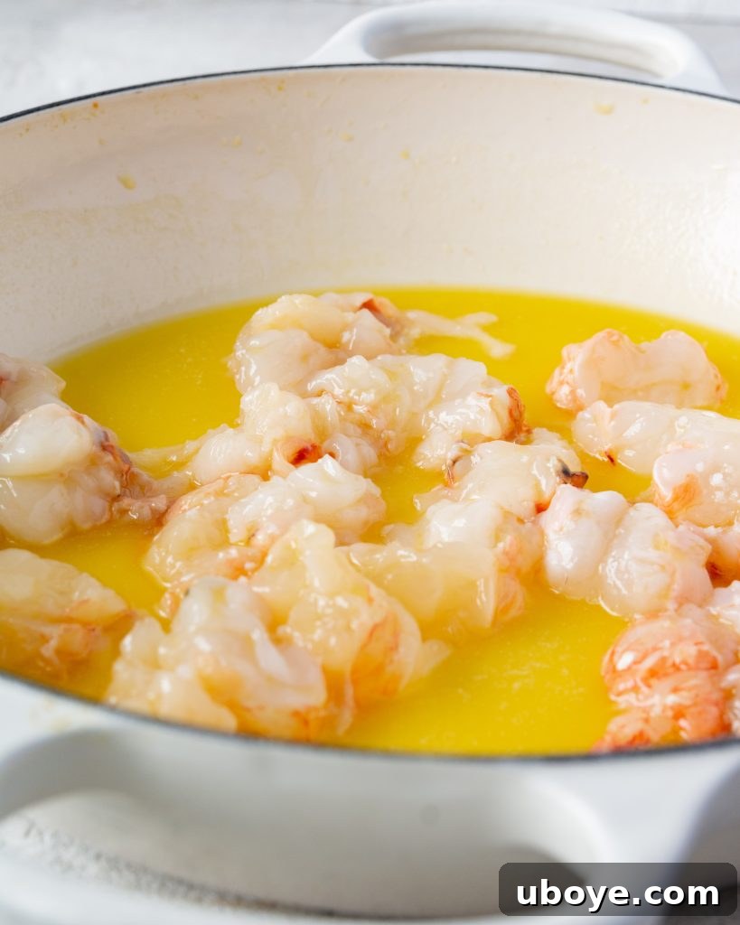 A chef's hand stirring a rich, simmering bisque in a pot.