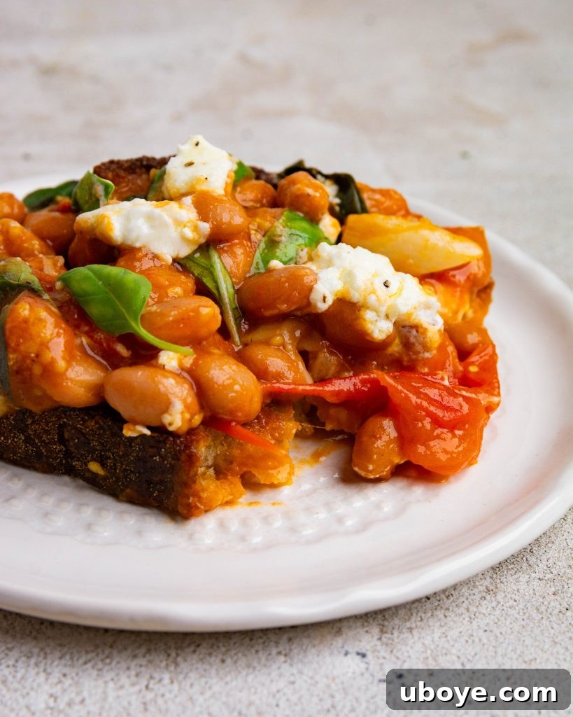 Rustic Tomato Garlic Beans 2 Delicious and healthy tomatoey garlic beans served in a bowl with toast.