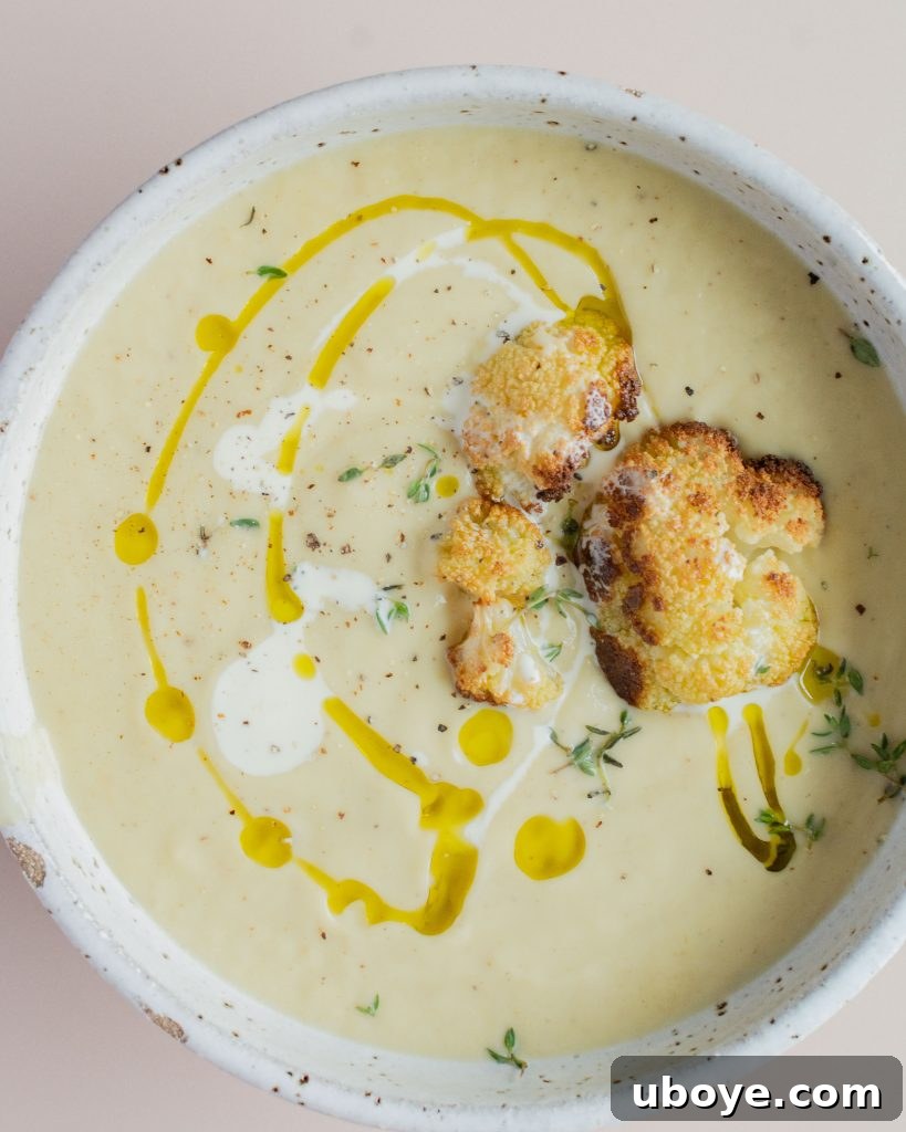 Creamy Cauliflower Delight 2 Rich and creamy cauliflower soup in a bowl with fresh herbs.