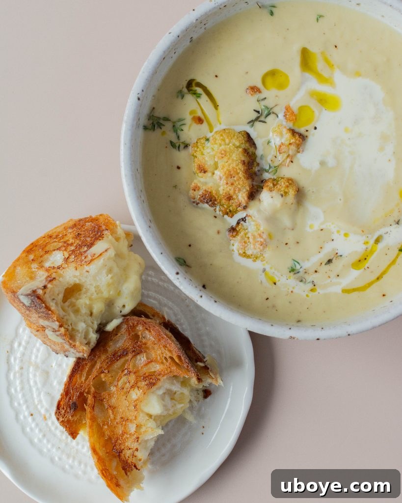 Creamy Cauliflower Delight 5 Ingredients for cauliflower soup laid out: cauliflower, garlic, leeks, and thyme.