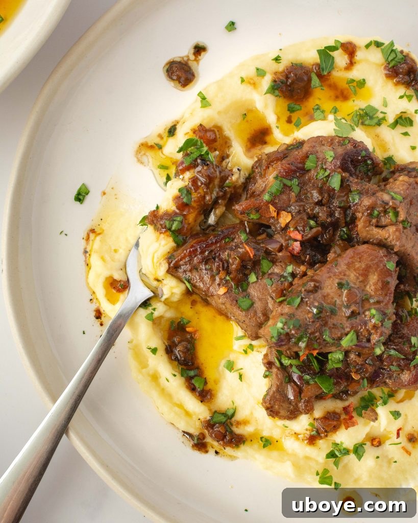 Close-up of garlic butter steak bites in a pan, showcasing their golden-brown sear and glossy butter sauce.