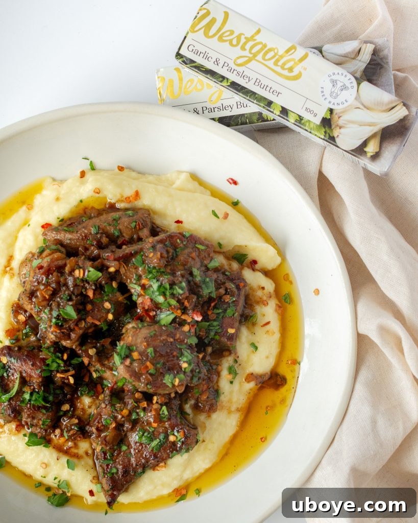 Garlic butter steak bites being tossed in a skillet with the savory butter sauce.
