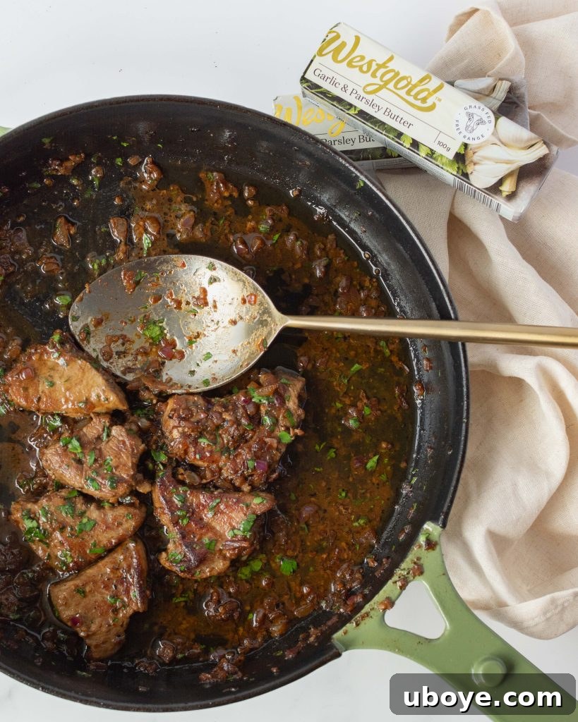 Garlic butter steak bites served with a side of creamy mashed potatoes and fresh parsley garnish.