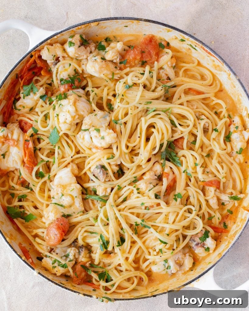 Velvet Lobster Pasta 9 A large serving bowl filled with creamy lobster pasta, garnished with fresh herbs and a drizzle of olive oil.