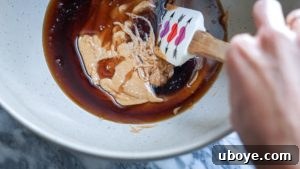 Wet ingredients for cereal bars being mixed in a bowl.