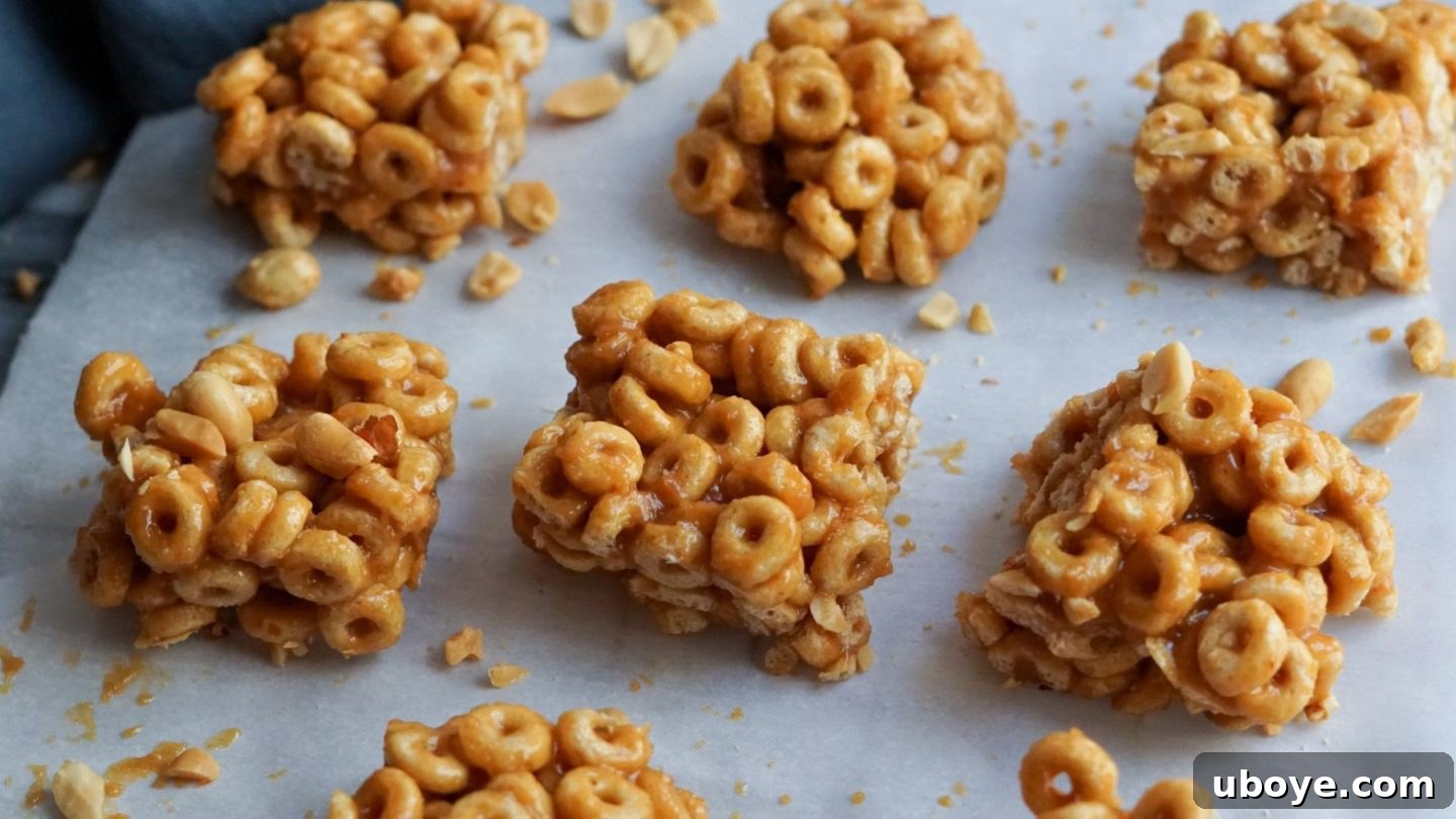 Bee-Free Honey Nut Cereal Bars 9 Neatly sliced vegan honey nut cereal bars arranged on a piece of white parchment paper.
