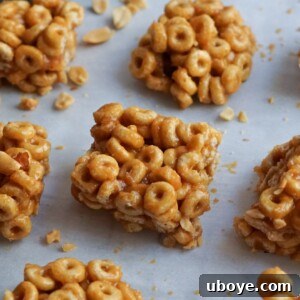 A vibrant image of delicious vegan honey nut cereal bars on a white surface, showcasing their appealing texture.