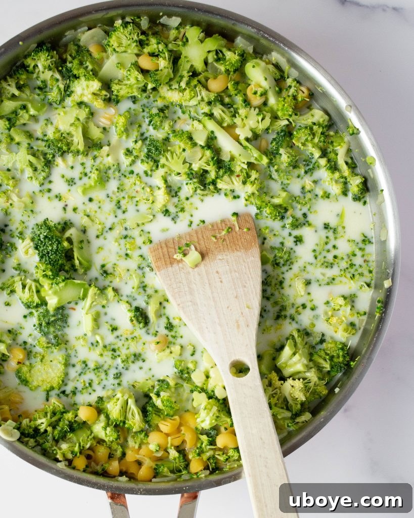 Effortless One-Pot Broccoli Pasta 3 Close-up of cooked broccoli florets mixed with pasta in a pan
