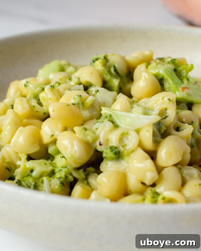 Effortless One-Pot Broccoli Pasta 4 Broccoli pasta being stirred in a large skillet, showing its creamy texture