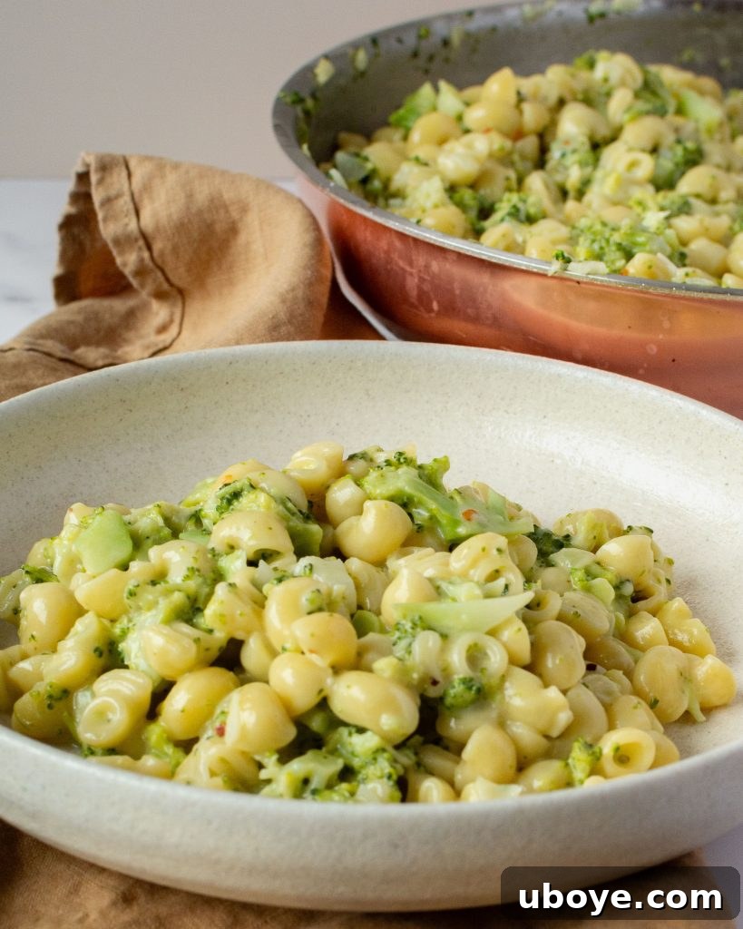 Effortless One-Pot Broccoli Pasta 7 Uncooked short pasta (e.g., penne or fusilli) on a wooden board