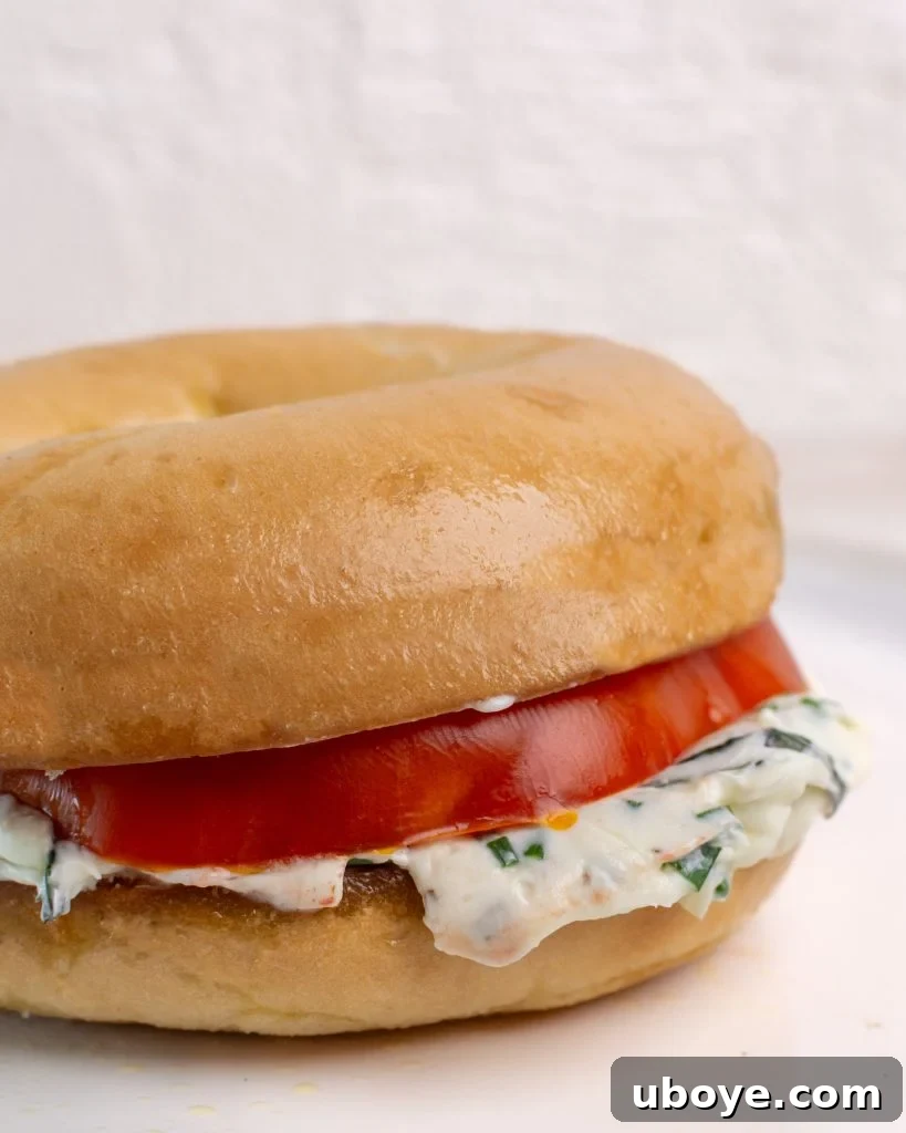 Bagel with Cream Cheese Perfection 10 Assembled cream cheese bagel with tomato, ready to be enjoyed