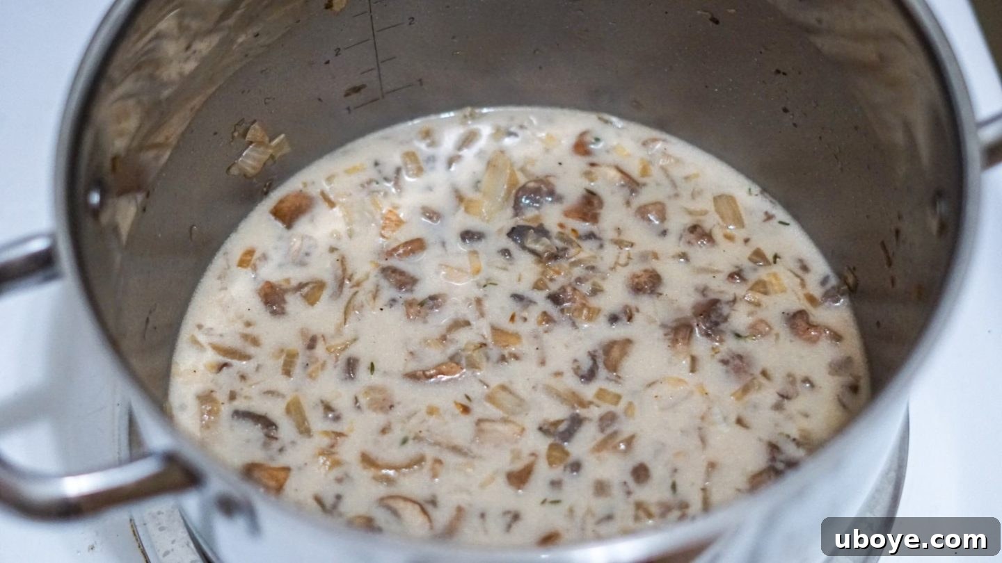 Creamy Mushroom Dream Pasta 4 Sautéed mushrooms, garlic, and fresh thyme simmering in a pot, their aromas mingling to create a rich and savory foundation for the pasta sauce.
