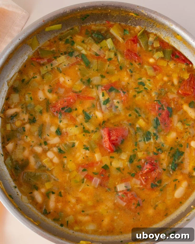 Lemony Brothy Beans with Scallops, garnished with chili flakes and parsley