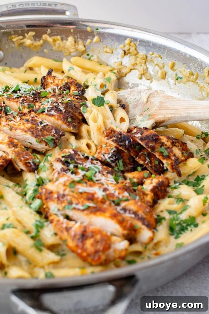 Single Skillet Creamy Chicken Alfredo 3 Close-up of creamy chicken alfredo with penne pasta and fresh herbs