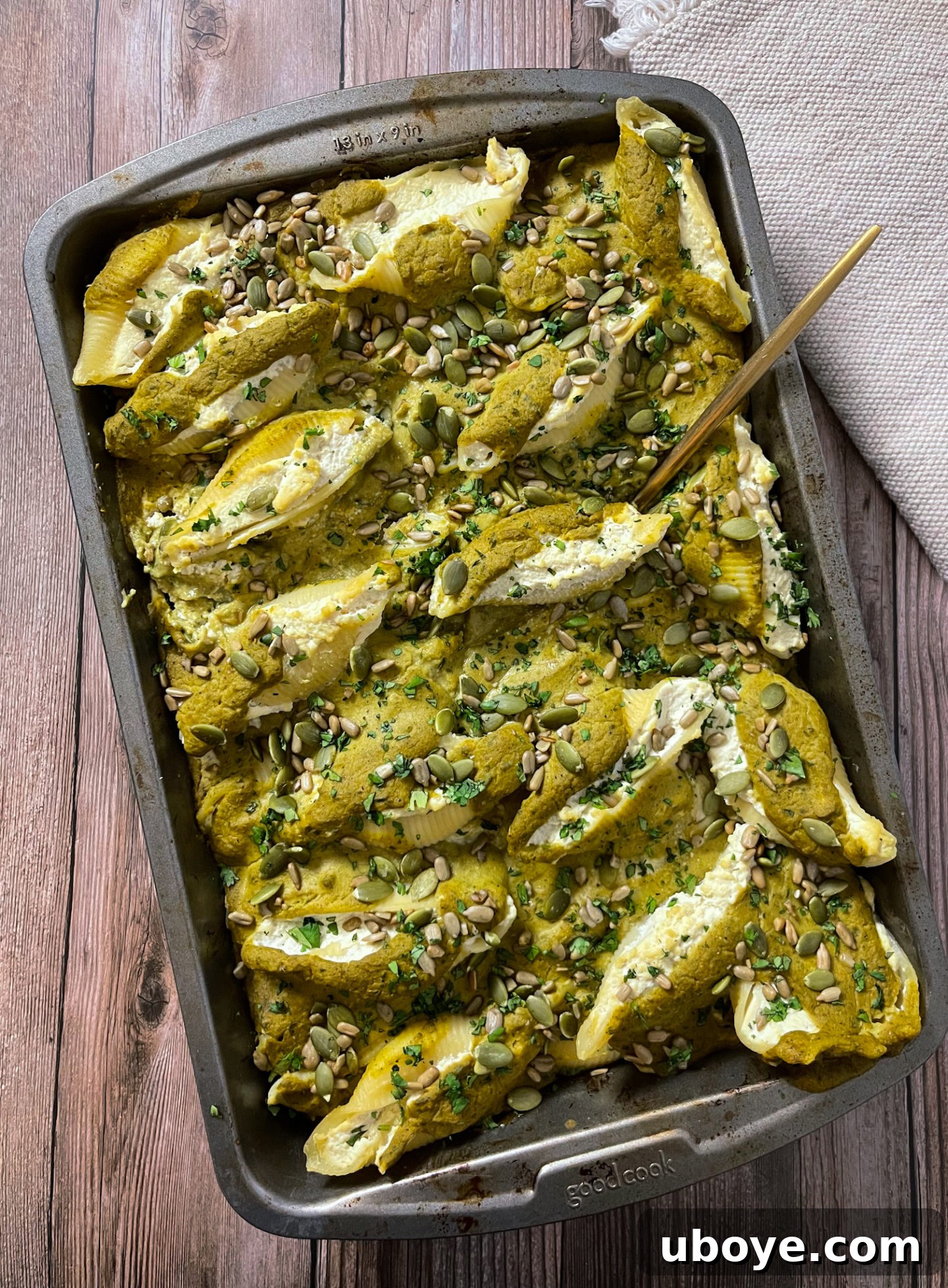 Close-up of baked Pumpkin Poblano Stuffed Shells, showing the creamy sauce and filling