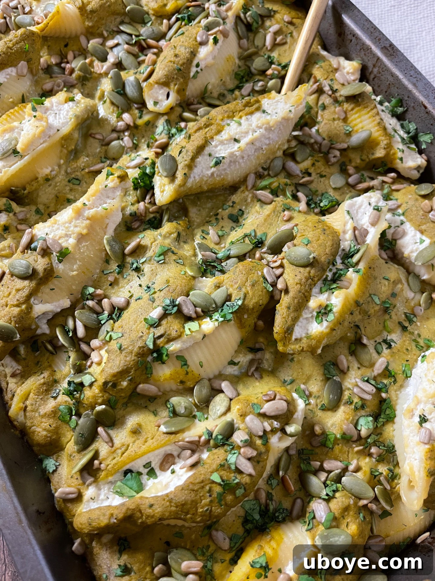 Close-up of raw ingredients for Pumpkin Poblano Stuffed Shells, including fresh peppers, onions, and tofu