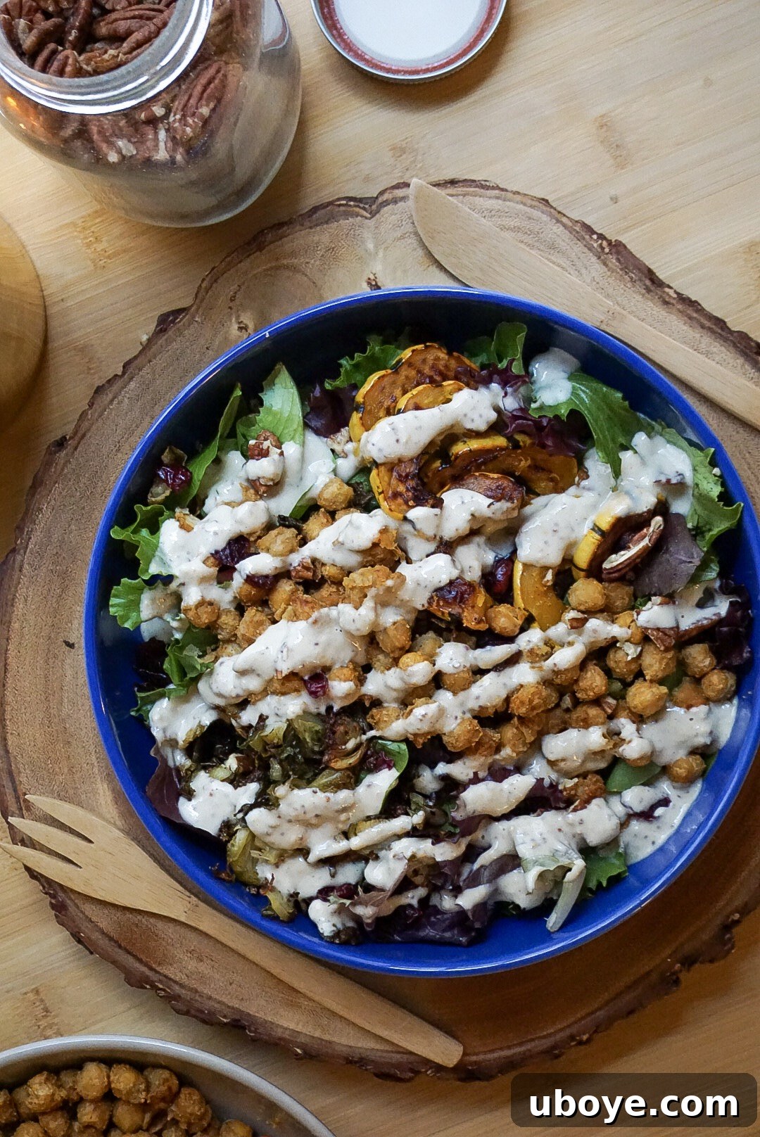 A close-up shot of a creamy, golden vegan maple mustard dressing, emphasizing its smooth texture.
