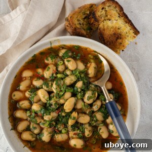 A vibrant bowl of Beans and Herbs, with toasted sourdough, illustrating the finished dish.