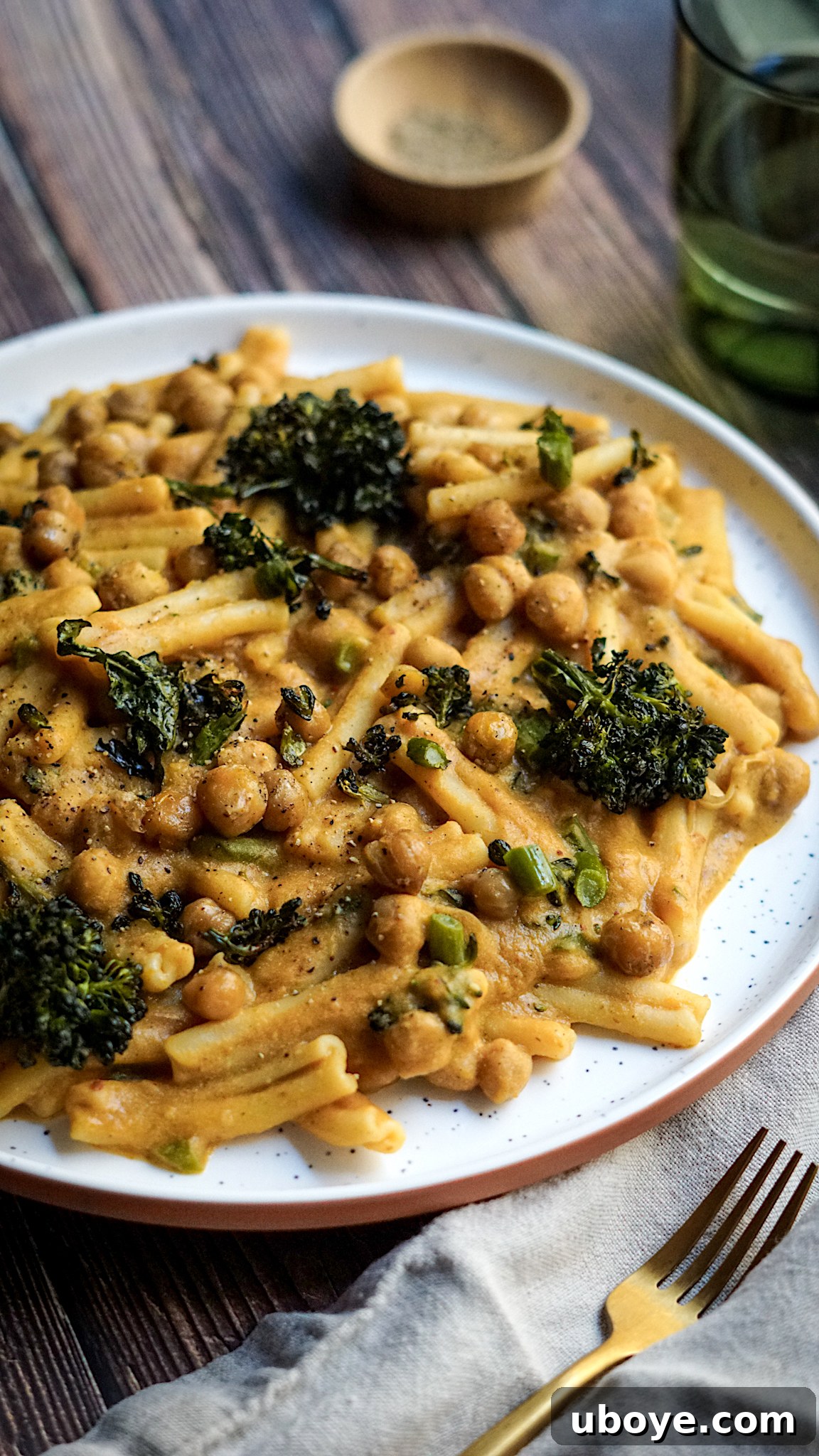 Warm Spiced Pumpkin Pasta with Charred Broccolini and Crispy Chickpeas 2 A vibrant bowl of Spicy Vegan Pumpkin Pasta topped with roasted broccolini, chickpeas, and fresh herbs.