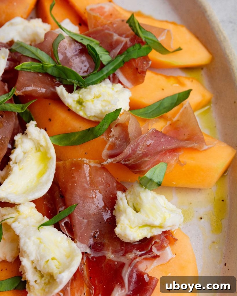Basil oil drizzled over a fresh salad with prosciutto and melon