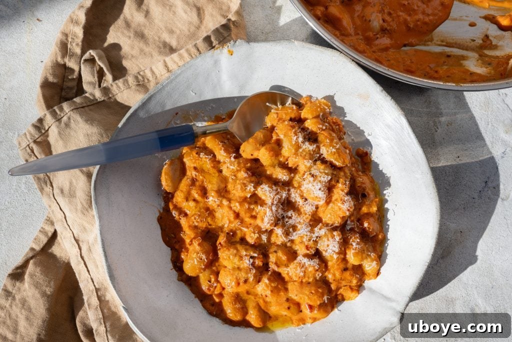 Spirited Bean Treats 7 Creamy butter beans perfectly coated in a rich, red vodka sauce, ready to be served.