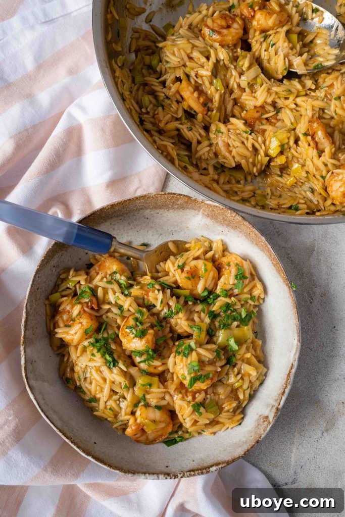 Shrimp searing in a pan for lemony shrimp orzo