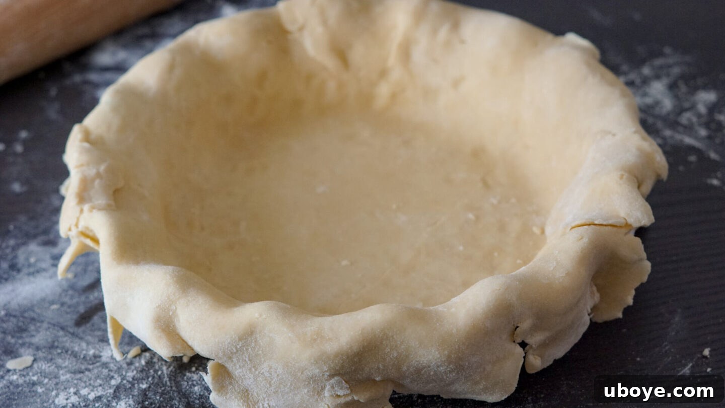 Timeless Vegan Apple Pie 8 rolling out vegan pie dough on a floured surface