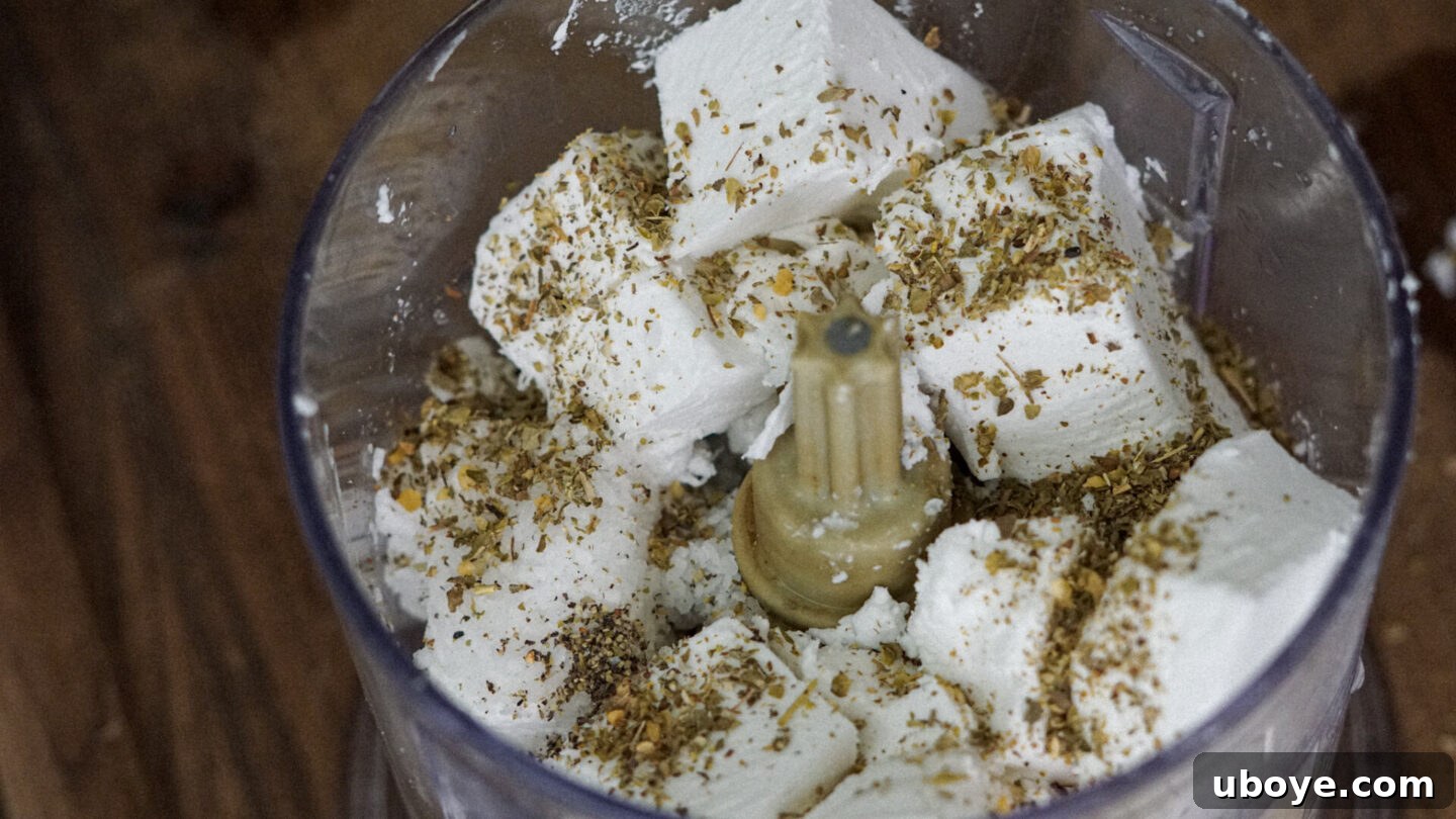Creamy whipped vegan feta being blended in a food processor, highlighting its smooth texture.