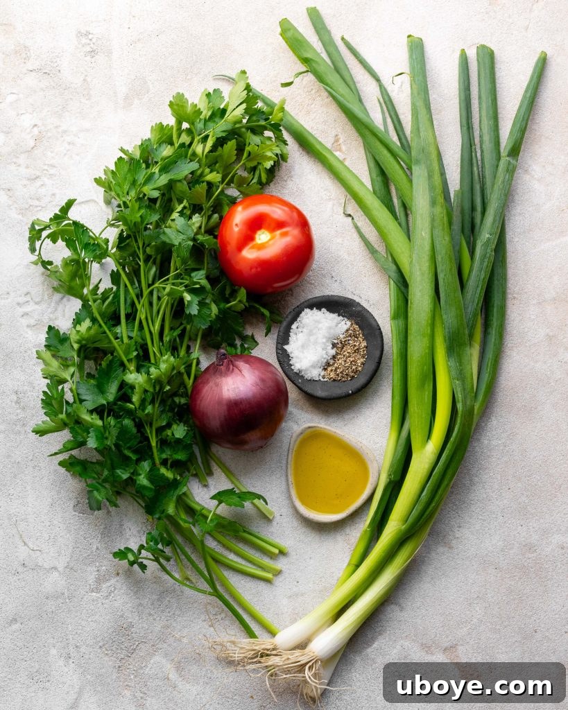 Freshly prepared Tabouli salad in a bowl, showcasing vibrant green parsley and diced red tomatoes.
