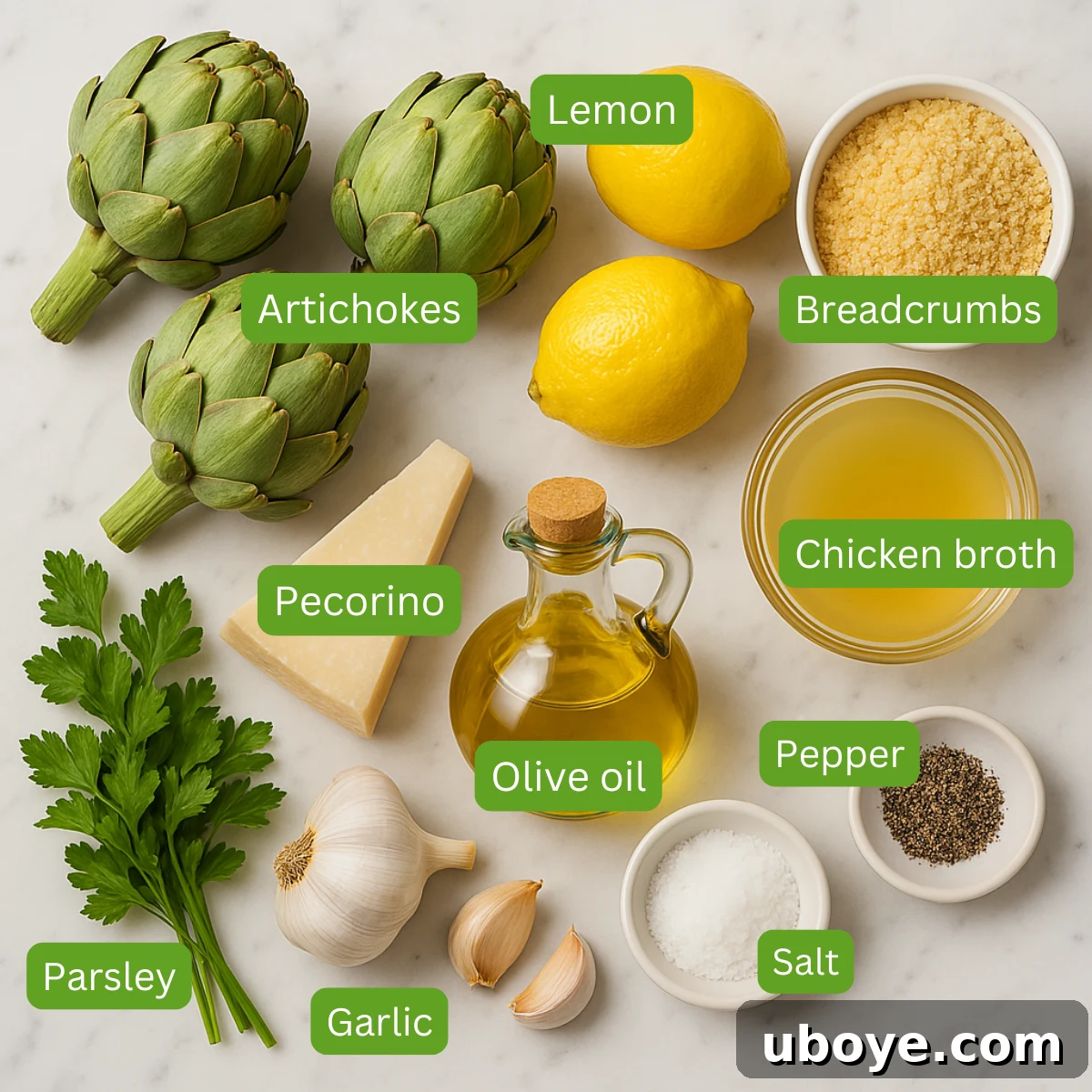 Close-up shot of fresh, vibrant green artichokes, lemon half, and garlic bulbs, key ingredients for the recipe.