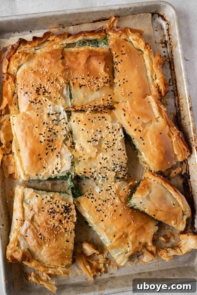 Perfectly baked golden brown Spanakopita, sliced and ready to serve